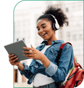 teen girl looking at her ipad with headphones on during teen mental health treatment