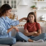 Young loving supportive mother trying to help anxious teen daughter