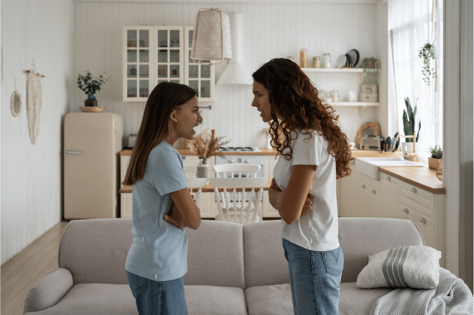 teen girls facing each other arguing at home