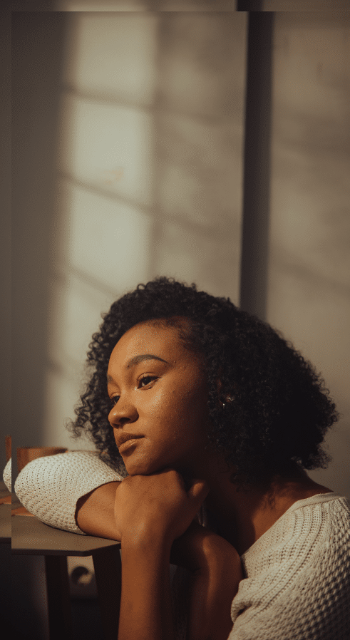 adolescent girl sitting on the floor while struggling with teen mental health