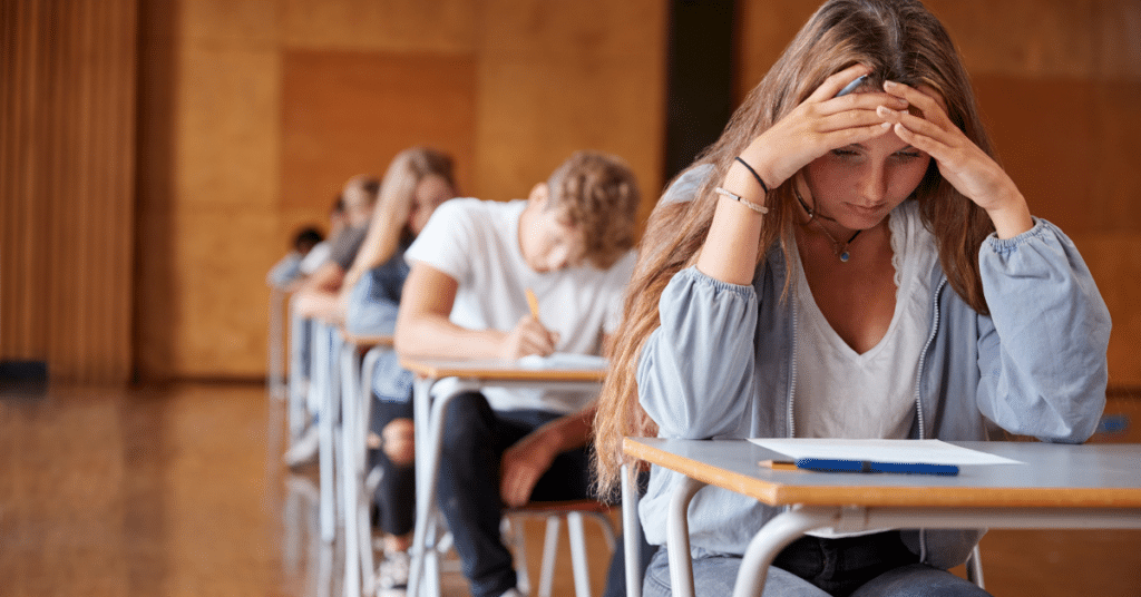 Teenagers sitting an exam with exam stress