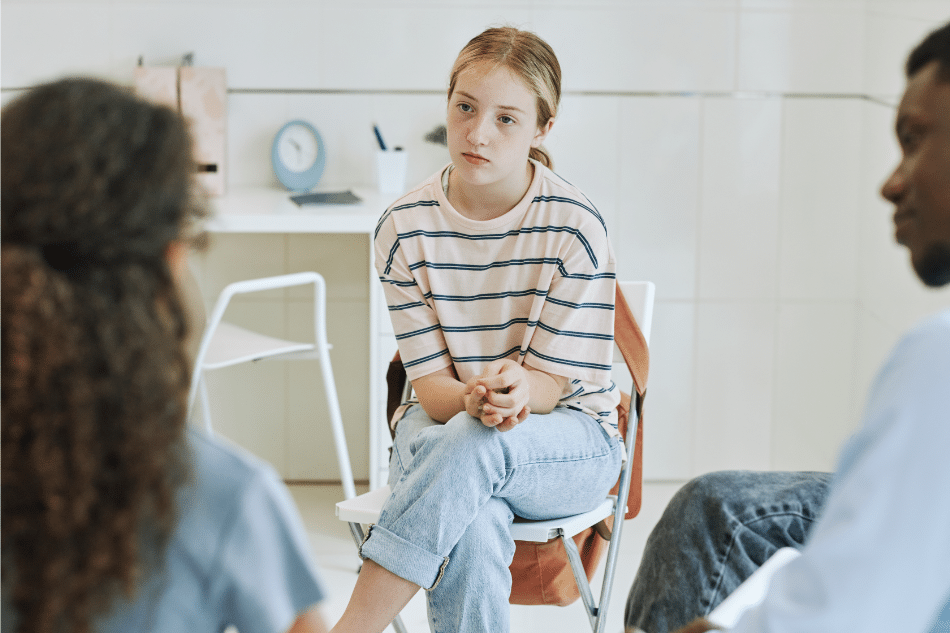 Girl in group therapy as part of school resources and counseling support for teen depression