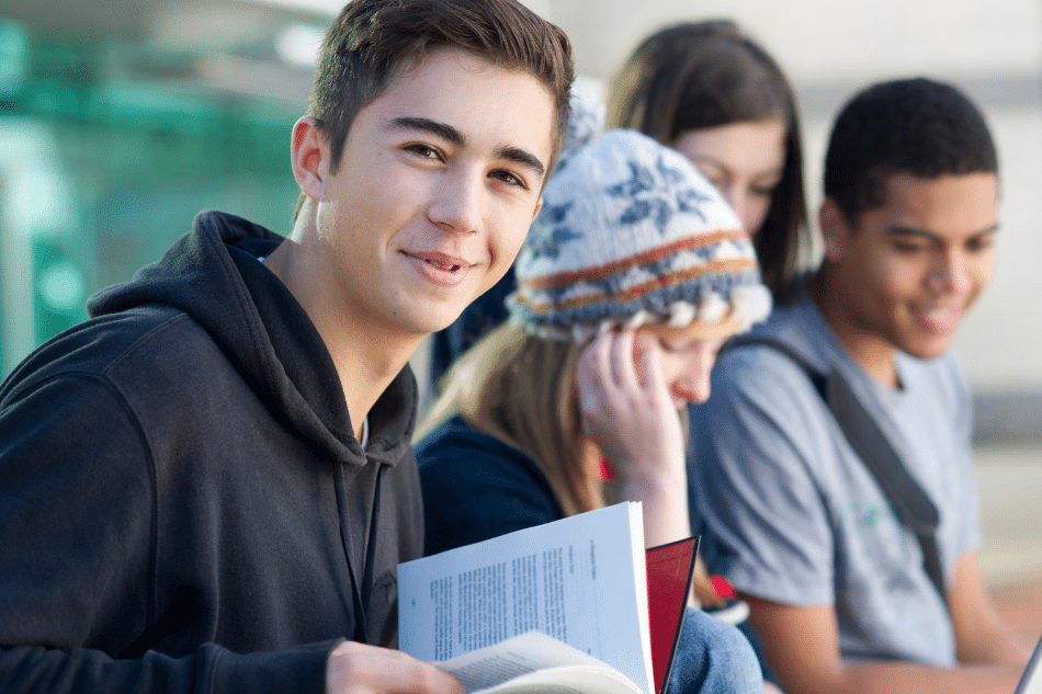 Teenage boy with friends smiling after Light Therapy for Seasonal Affective Disorder in Teens