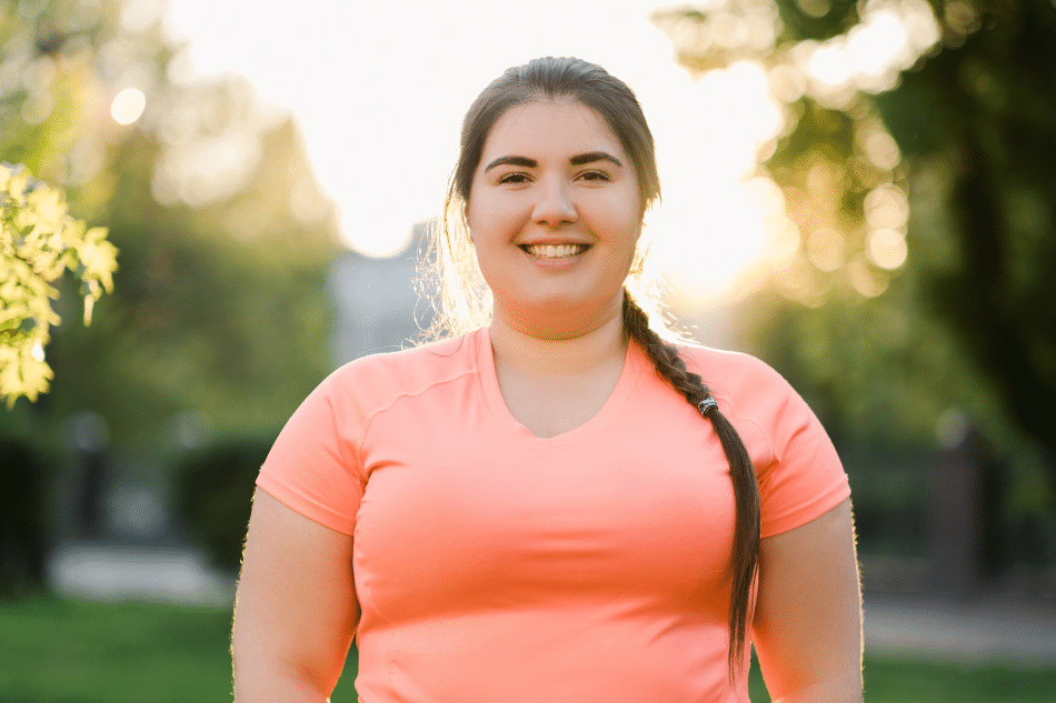 Teenage girl with dissociative identity disorder outside in pink exercise clothing