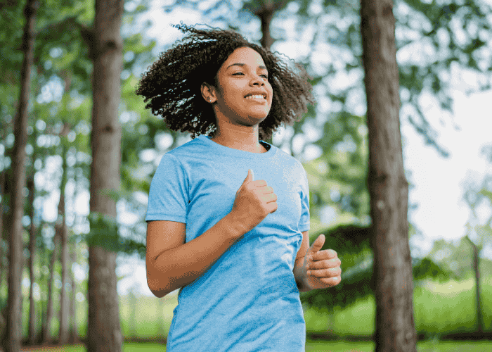 Teenager living with psychosomatic disorders jogging in a woodland