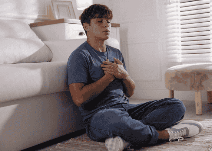 Teenage boy breathing mindfully for mindfulness-based cognitive therapy