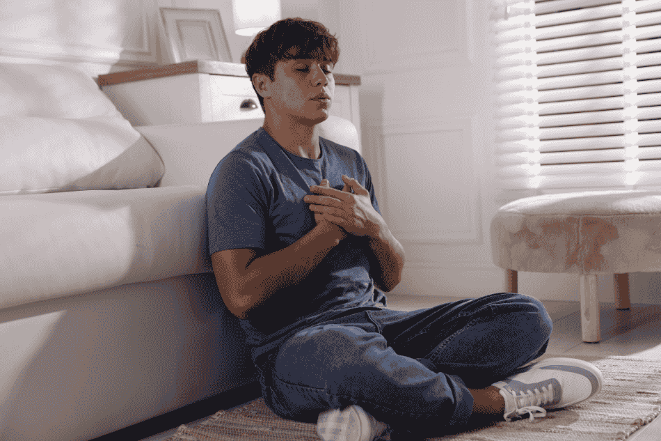 Teenage boy breathing mindfully for mindfulness-based cognitive therapy