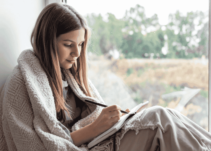 Teenage girl journaling for mindfulness-based cognitive therapy