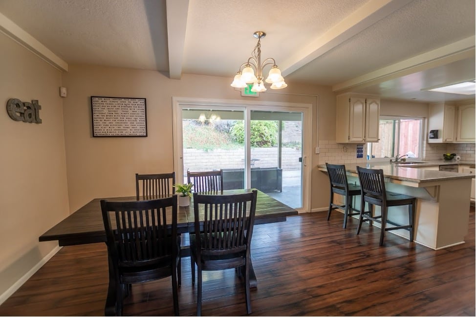 Dining room of Mission Prep facility with black furniture and hardwood floors.