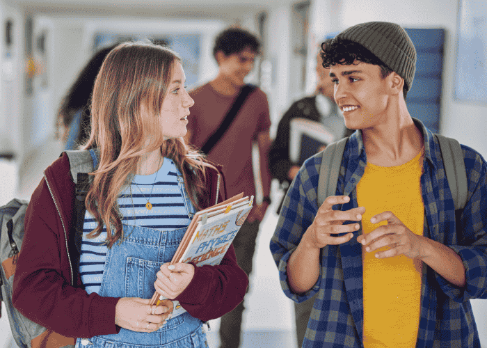 Teenage boy talking to friend in school hallway after support for when his mind goes blank