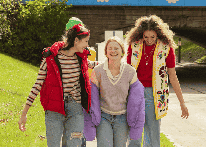 Group of teenage girls laughing and smiling after receiving treatment for anhedonia in teens
