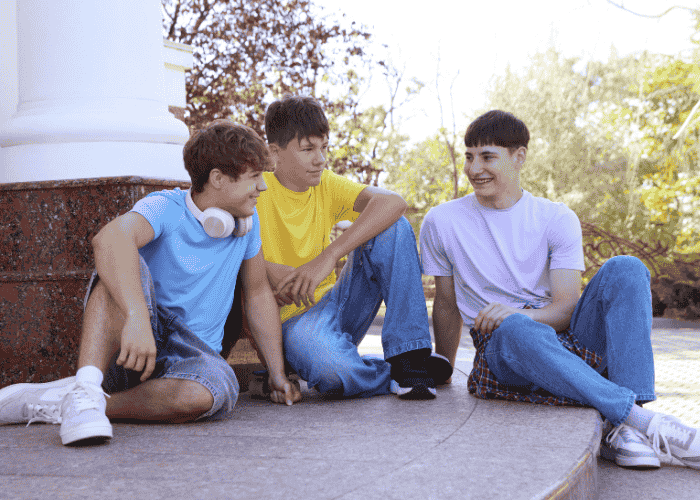 Teenage boys laughing together after receiving treatment for stress weakened immune system