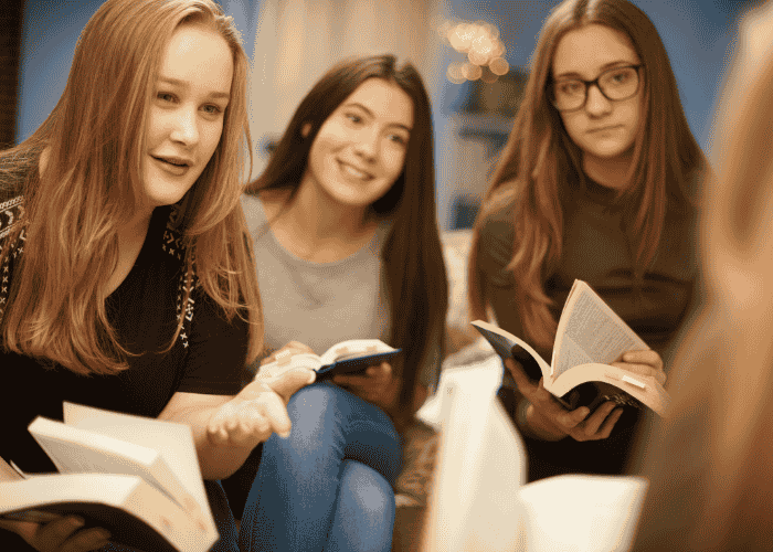 Three teenage girls studying together after receiving treatment for social comparison