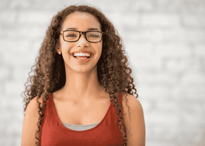Teenage girl smiling after receiving treatment for changes in sexual curiosity