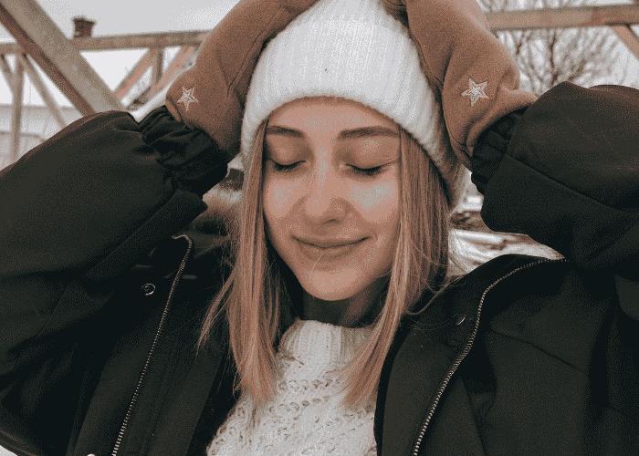 Teenage girl smiling due to receiving treatment for over apologizing in teens