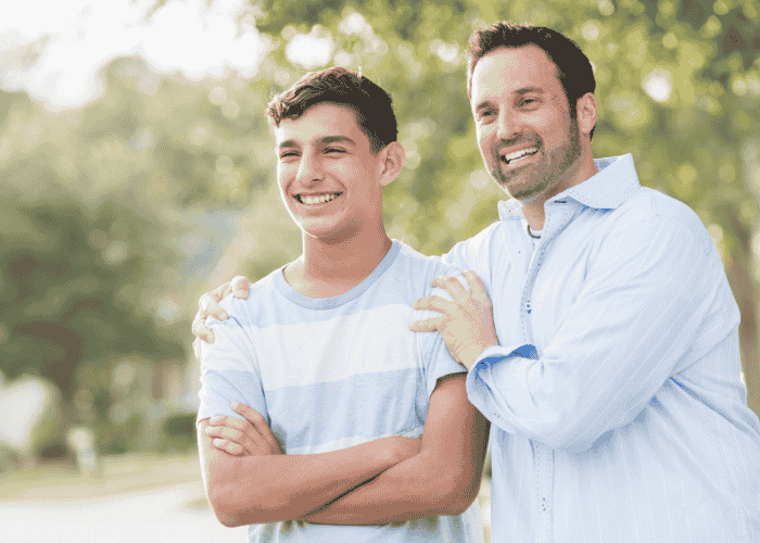 Dad with teen smiling after seeking support using Anthem mental health coverage