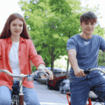 teen girl on bike ride in city with friend smiling after support with anxiety in neurodivergent teens
