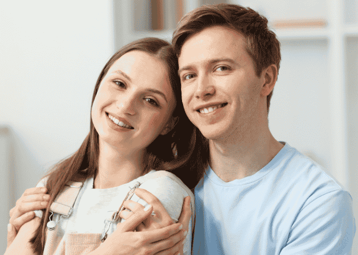 Teen boy smiling and hugging girlfriend after support for coping with limerence in teens