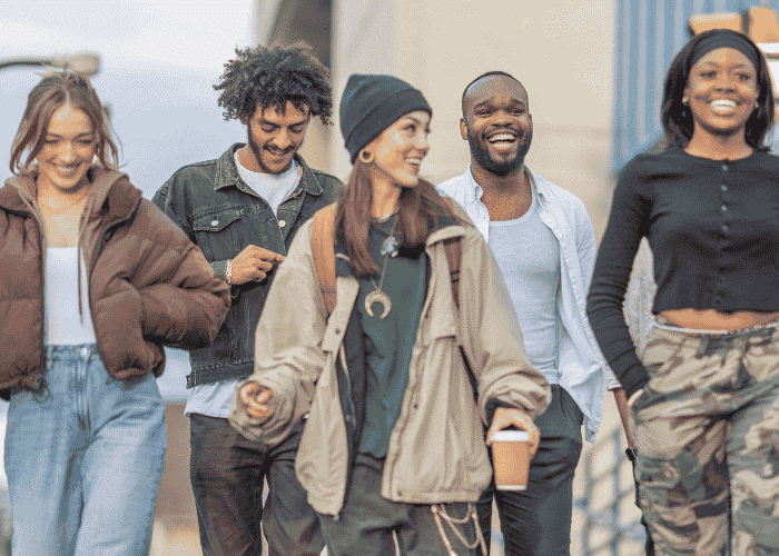 Group of youth walking and laughing after planning California youth mental health campaigns