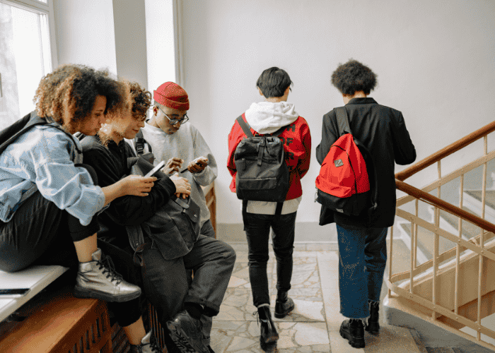 Teenagers in the hallway at school talking about youth mental health in Virginia