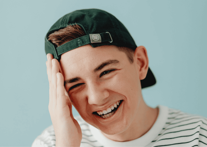 Teenage boy smiling after receiving treatment in a school's trauma-affected students program
