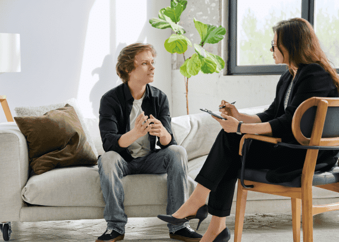 Teenage boy in therapy session after researching when to talk to someone about your mental health