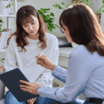 Teenage girl in therapy session after support with understanding California mental health parity and youth care