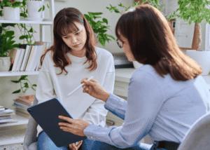 Teenage girl in therapy session after support with understanding California mental health parity and youth care