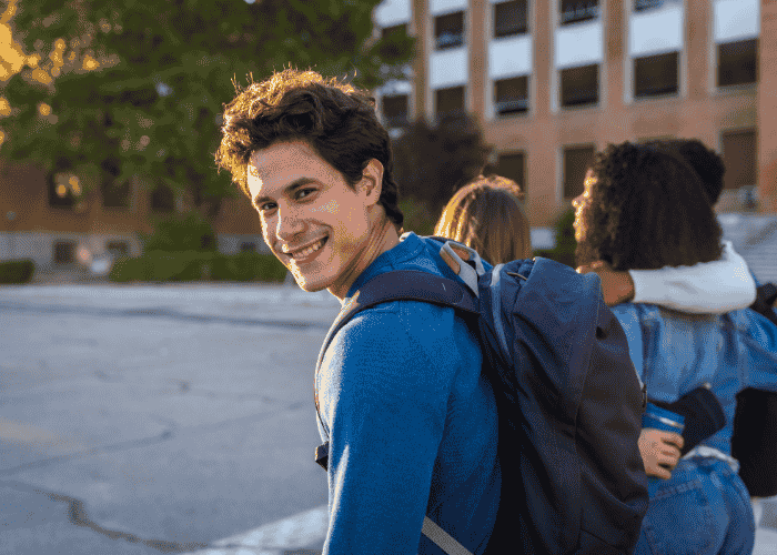 Teenage boy smiling after understanding how everyday stress affects teens with childhood trauma