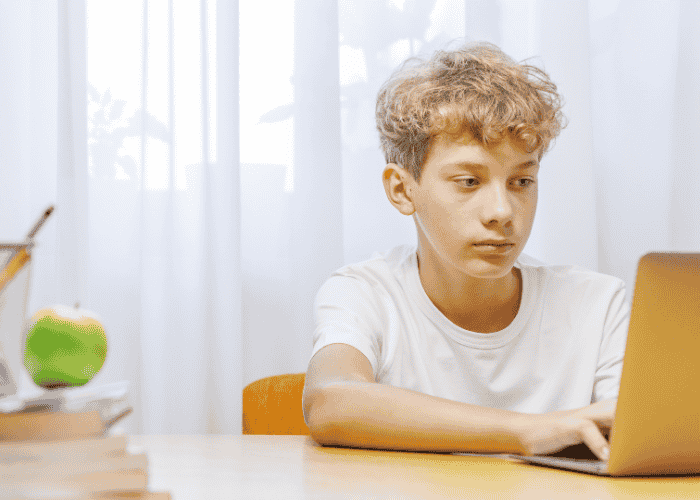 Teenage boy on his laptop experiecing adhd paralysis in teens