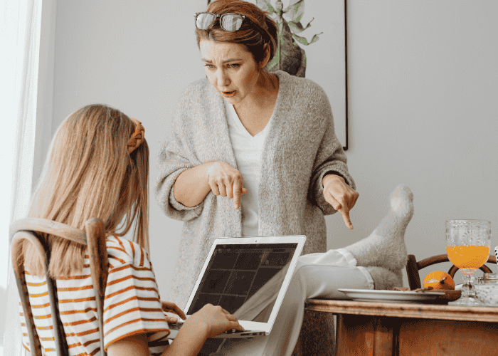 Mom angry at teen daughter sitting with feet on the table needing support with parent-teen conflict