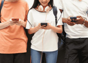 Teenagers using cell phones after receiving support with California teen digital safety