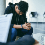 Teen boy sitting on sofa accessing therapy session after support with new laws in Virginia