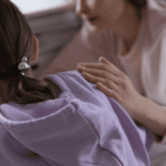 Mom putting hand on teen daughter's shoulder to comfort and needing support with talking to your teen about residential treatment