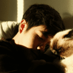 Teen boy laying on bed needing support with pet grief