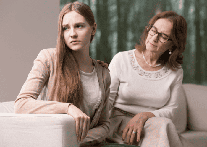 Mom sitting on couch with teen considering second opinions before admission