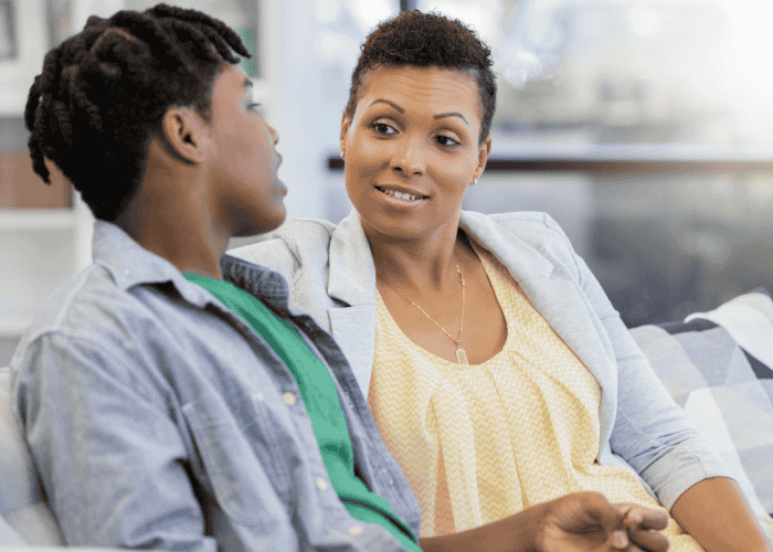 Mom sat with teen boy sitting wanting support with preparing your teen for admission