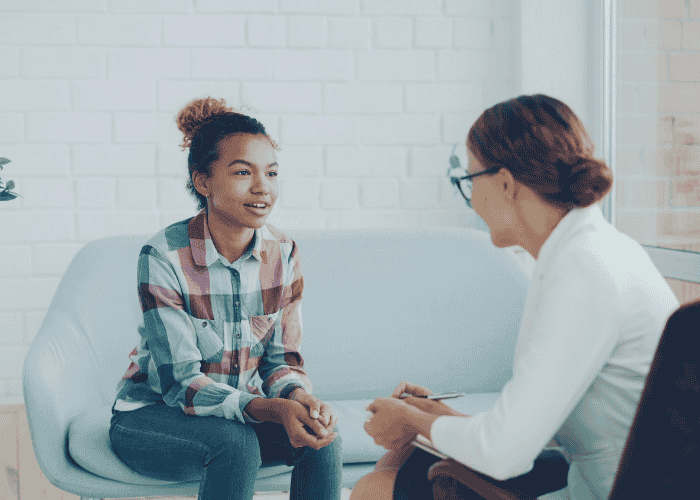 Teen girl in therapy session after support with faith vs clinical decision factors