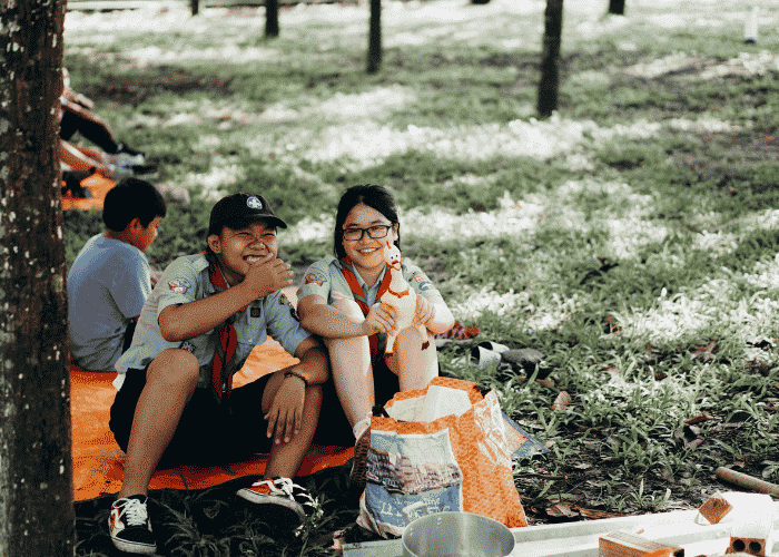 Boy and girl laughing at scouts after future vision planning for teens