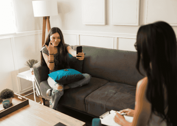 Teenage girl in therapy room expressing her identity after trauma
