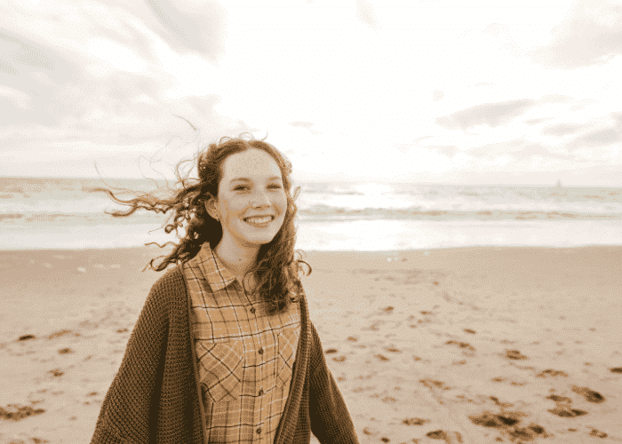 Teenage girl on beach not worried about her identity or peer acceptance