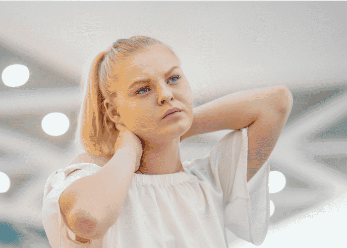Girl will hands behind her neck struggling with LGBTQ+ Teen Depression and Anxiety