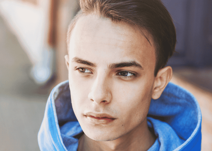 Teen boe walking though city struggling with LGBTQ+ teen mental health