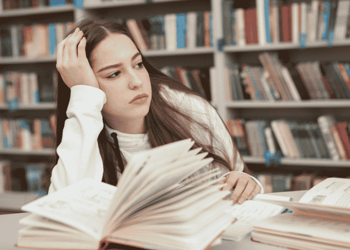 Girl sitting in library deep in thought in need of Self-Advocacy Skills for Teens