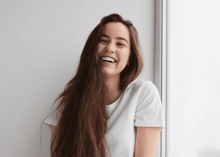 Teenage girl looking happy after Trauma-Informed Care for Neurodivergent Teens