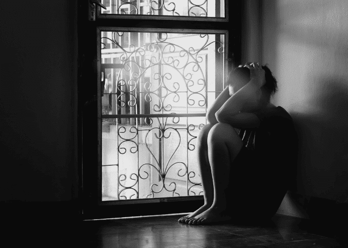 Woman with her hands on her head struggling due to monitoring vs trust after discharge