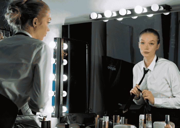 Girl looking in the mirror in need of body image healing for teens