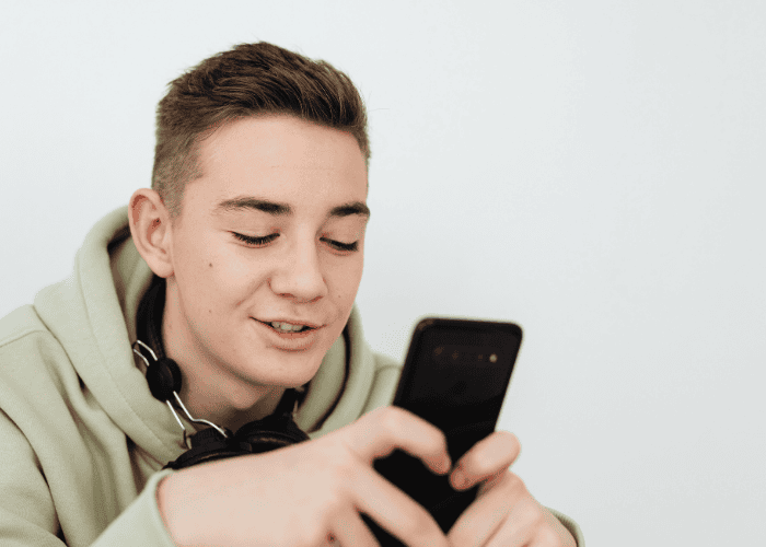 Teen looking at phone, how to safeguard internet access