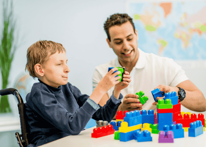 Neurodivergent teenager playing with block during therapy for neurodivergent teens