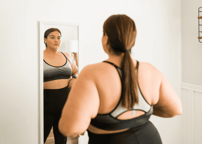 teenage girl looking at herself in the mirror, representing identity in teens